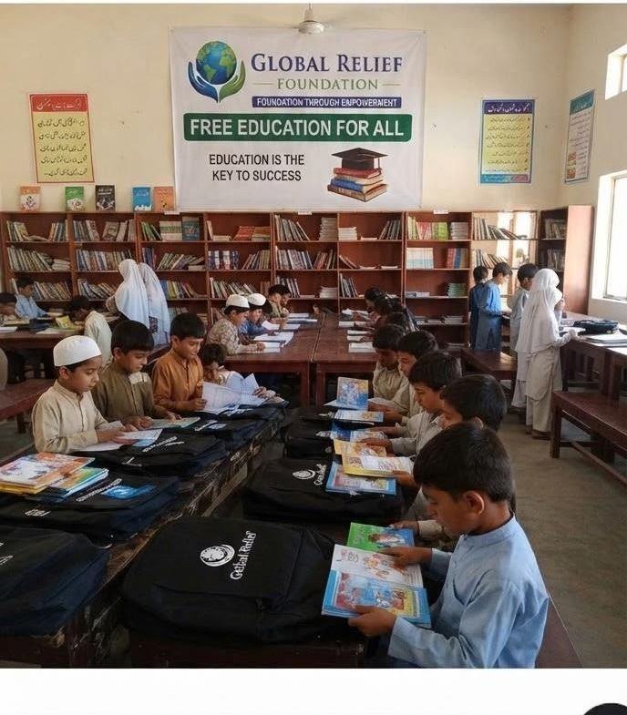 Children reading in a school library supported by GRF